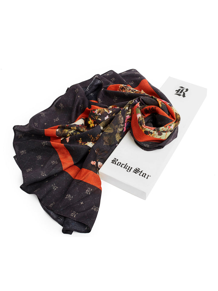This Rocky Star scarf features intricate floral motifs and deep red border with the brand monogram making it an elegant reign piece.  Style this scarf with your outfit to add an edgy note to your look. The beauty of this foulard is that the detail makes it a timeless essential.